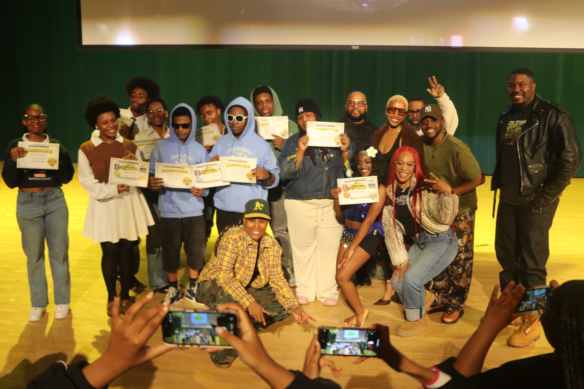 Students on stage with certificates at The Future Is Yellow talent show