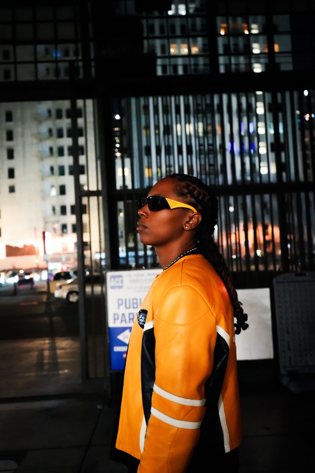Suni MF in profile on a city street at night