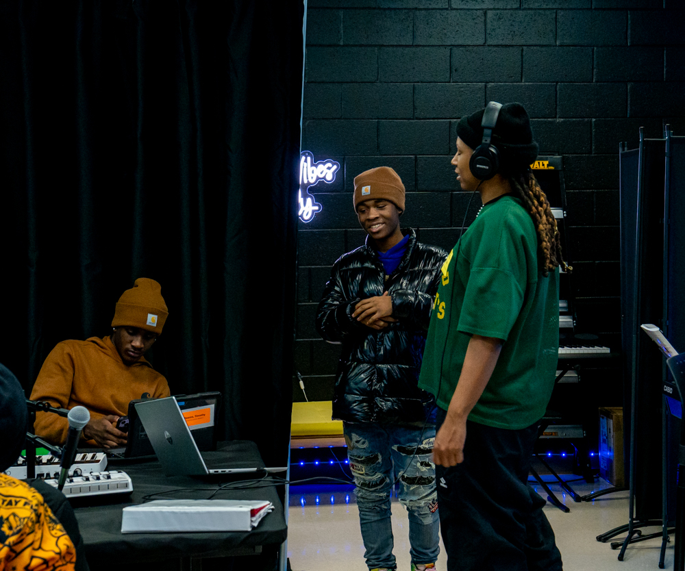 Students talking through a session in the classroom studio